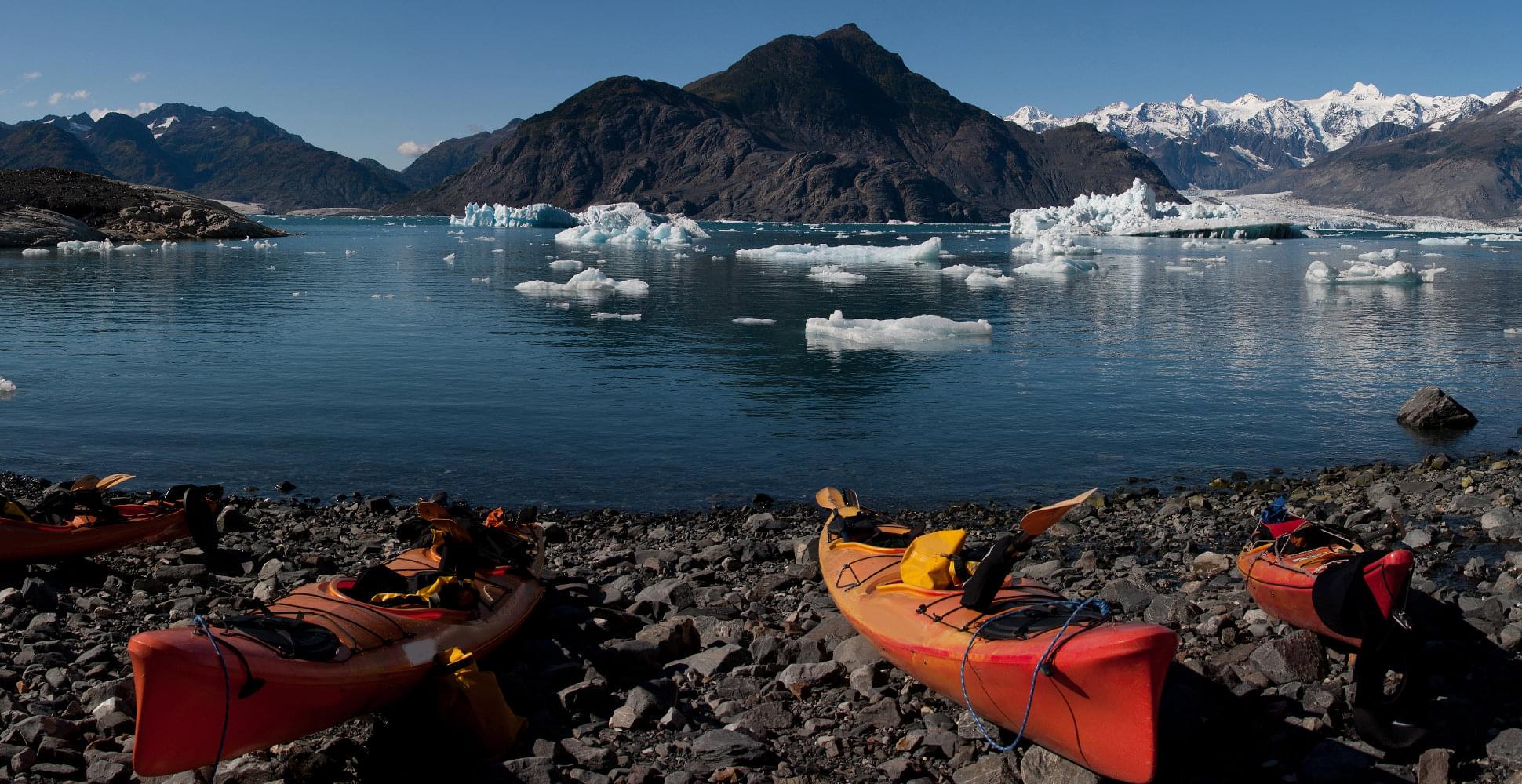 kayak and mountains near a glacier in alaska